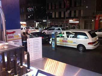 The HDD cart set up at an indoor venue with branded van